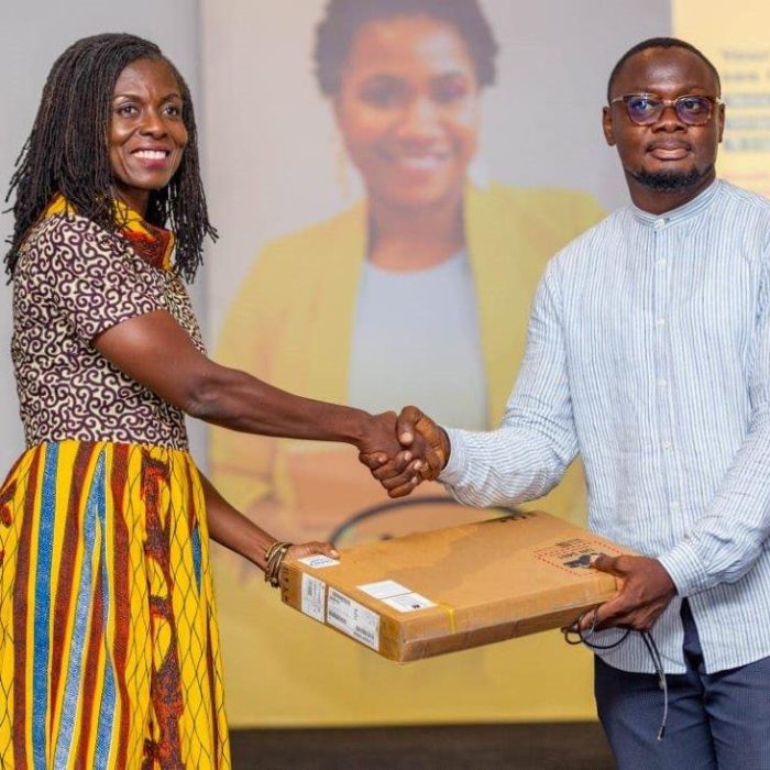 Adwoa Afriyie Wiafe- Chief Corporate Services and Sust. Officer-MTN presents prize to winner of raffle draw Enimil- Western Reporters
